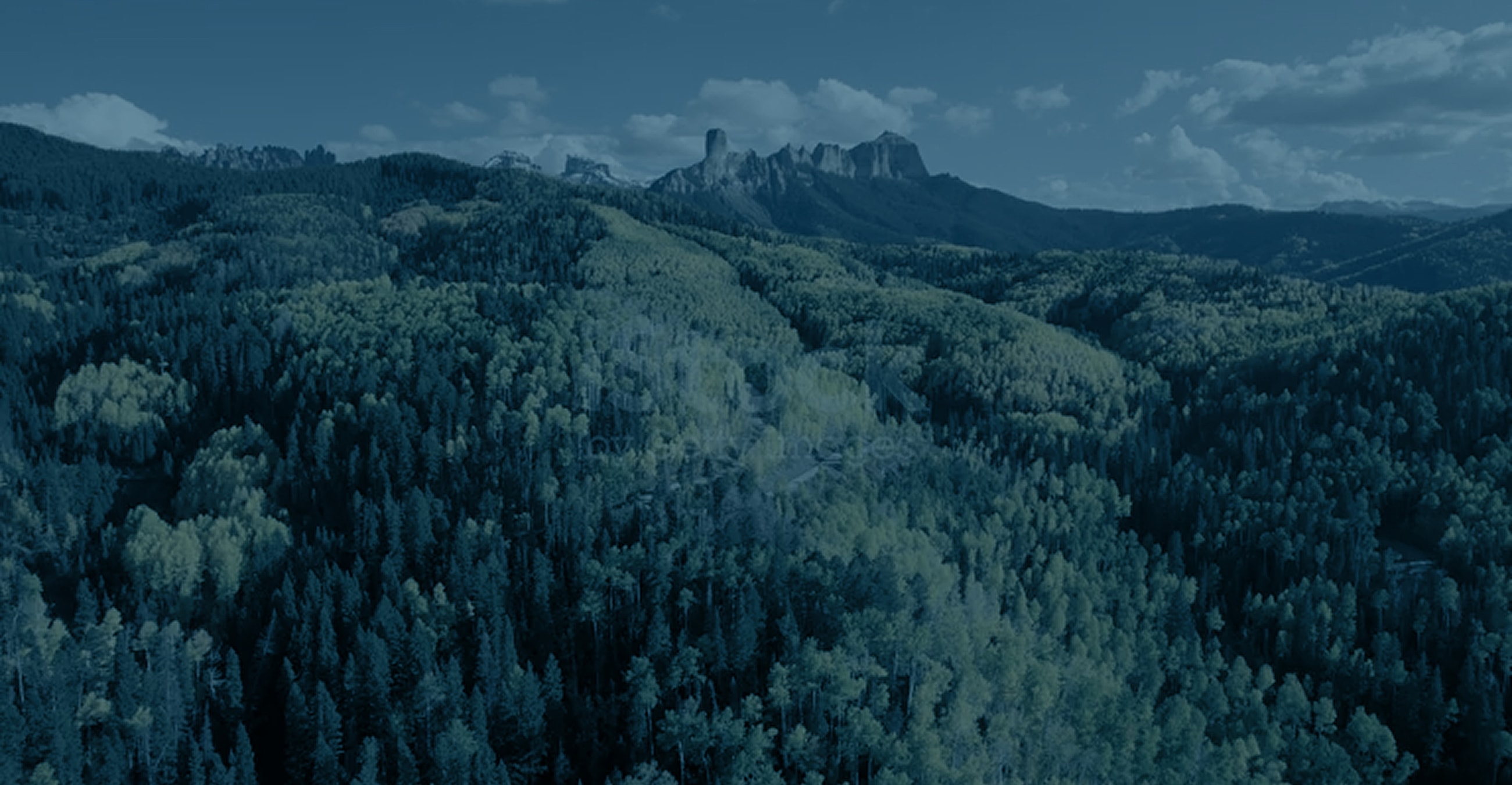 Layered mountains in soft, muted colors.