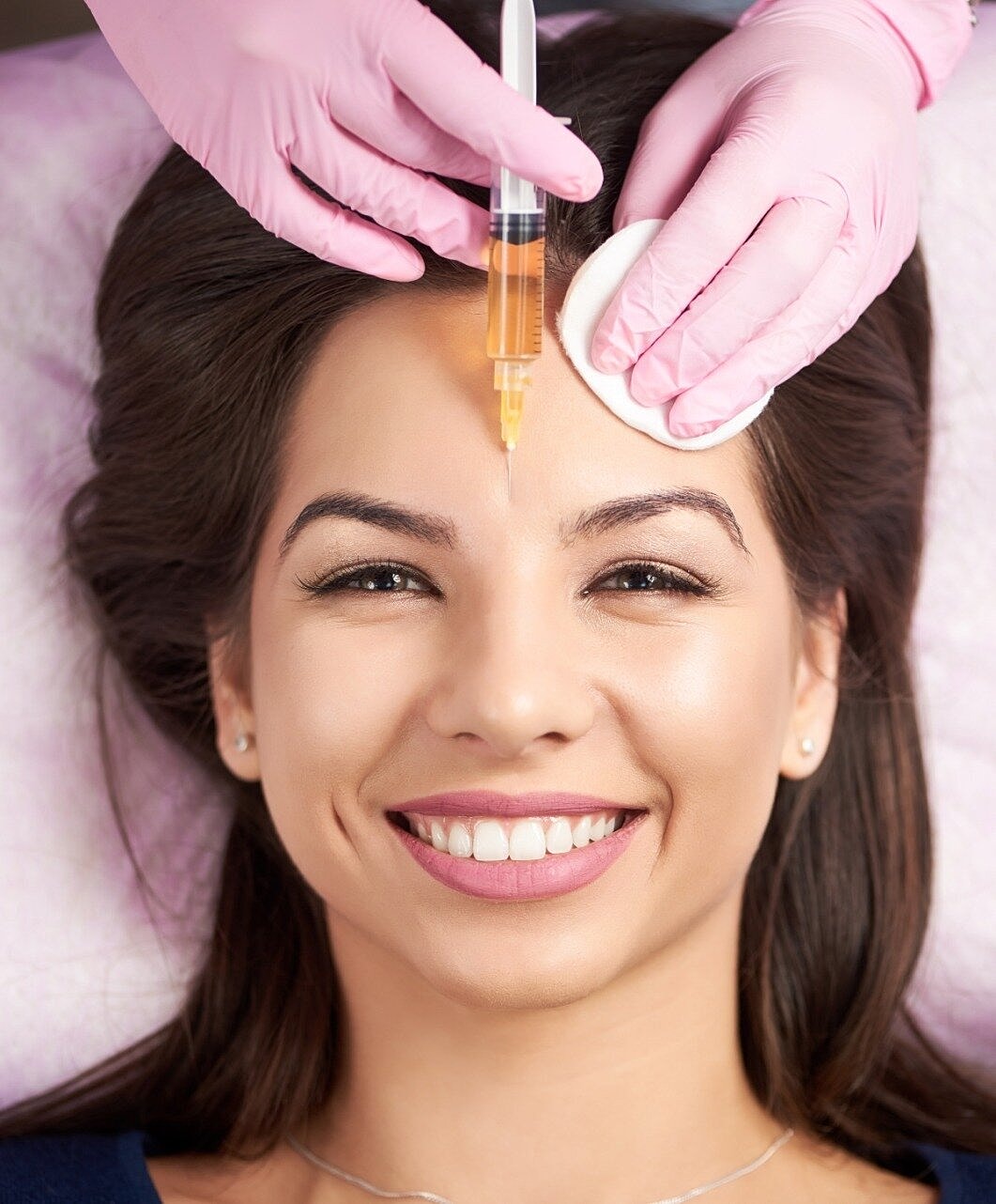 Young woman examining her acne with concern.