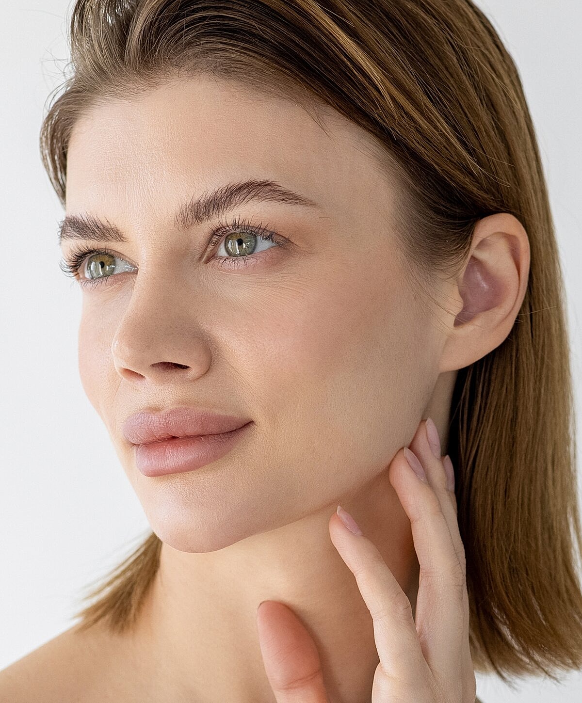 Denver Facial balancing model resting her chin on hands.