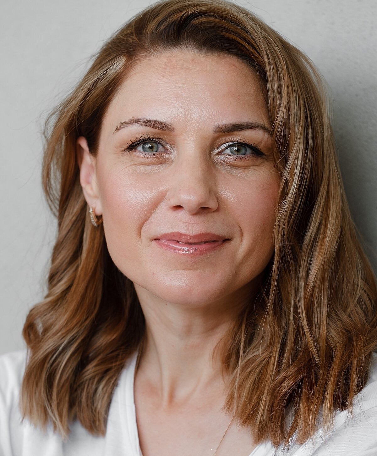 Denver Wrinkle Treatment model with medium-length wavy hair.