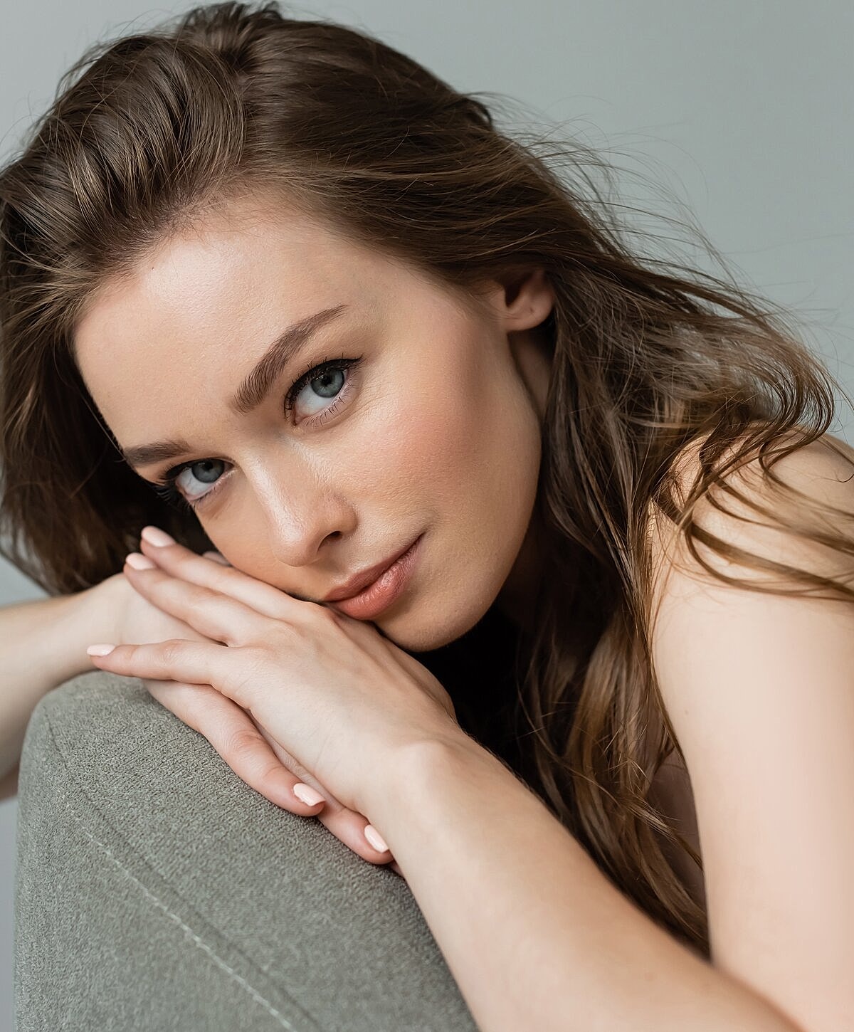 Denver Botox model resting her chin on hands.