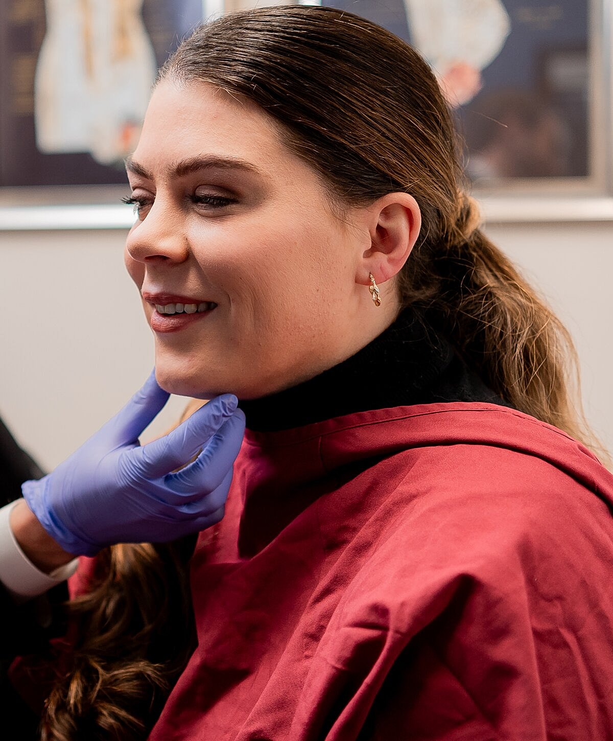 Denver Botox model smiling during a medical consultation.