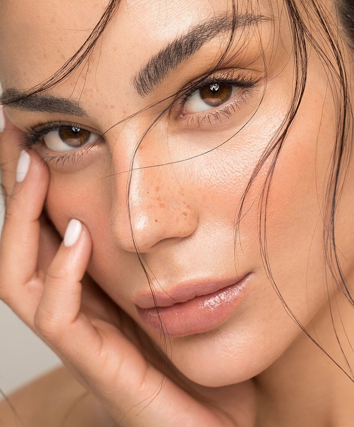 Close-up of woman with expressive eyes and skin.