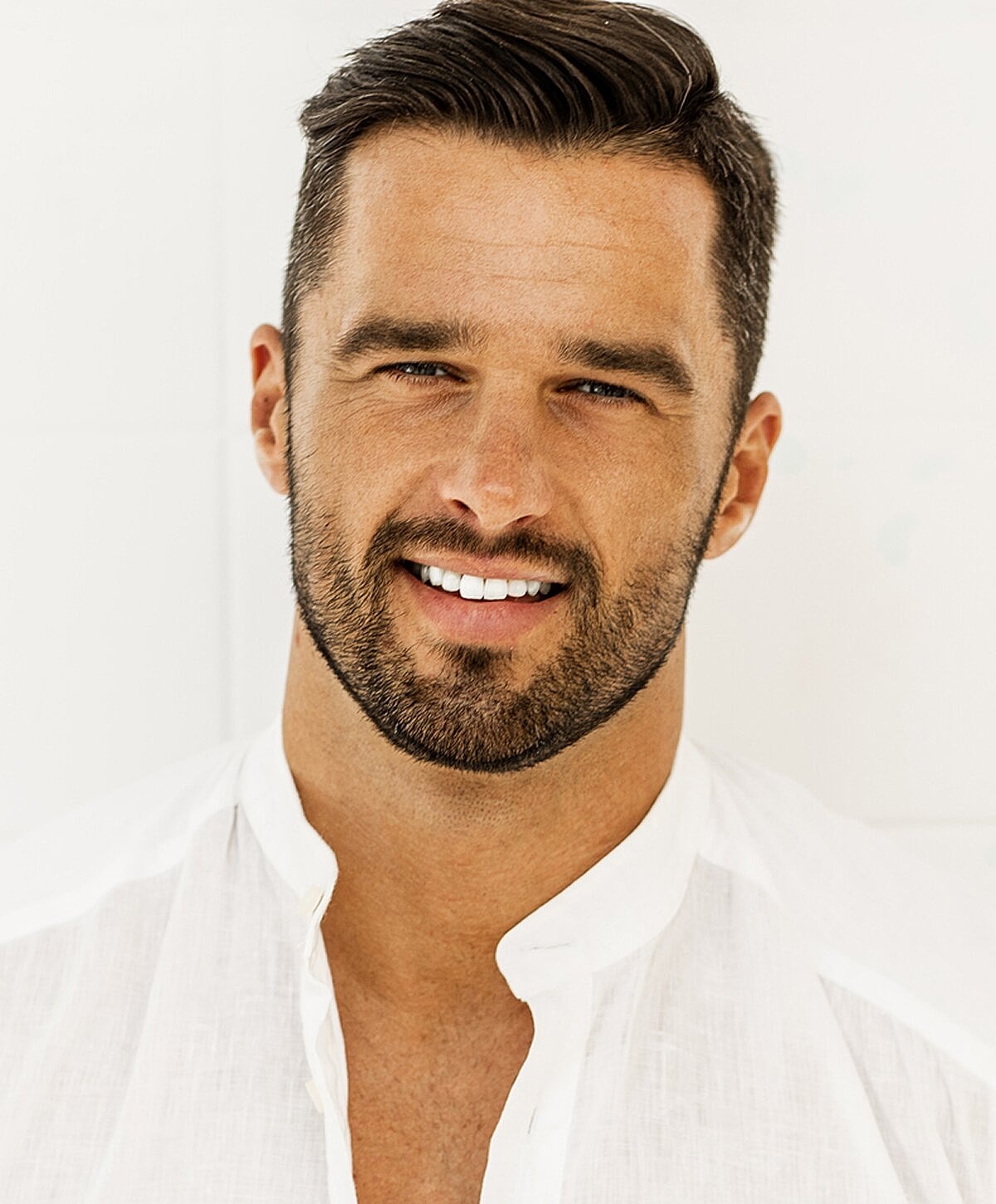 Smiling man in a white shirt portrait.