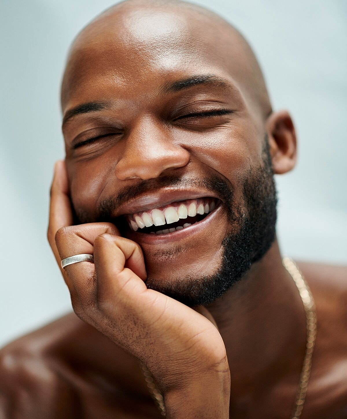 Denver Microneedling model resting his chin on hand.