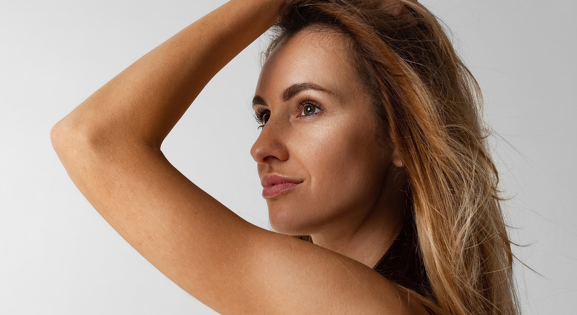 Profile of a woman with flowing hair.